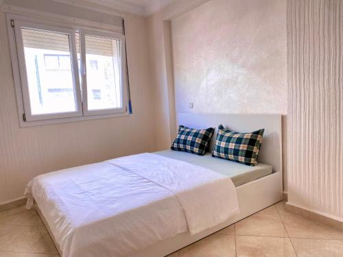 a bedroom with a bed with two pillows on it at Corazón de la Ciudad in Tetouan