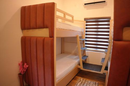 a room with two bunk beds and a window at Dune Homestay in Alleppey
