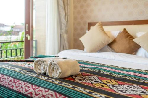 a hotel room with a bed with a towel on it at Modern 5BR Luxury Villa with Pool & Rooftop - 100m from Sanur Beach in Sanur