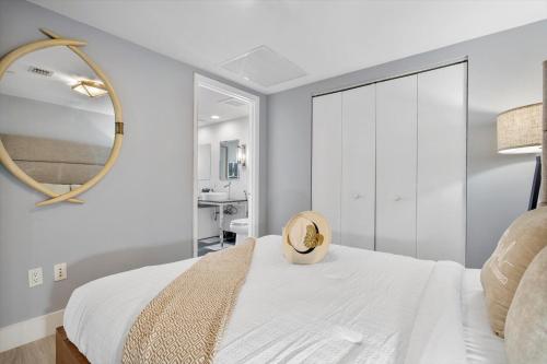 a bedroom with a white bed and a mirror at W hotel High end ocean view 2 bedroom at icon brickell in Miami