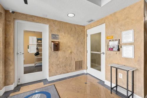 a room with two doors and a table on a wall at Beachfront 3br Condo With Stunning Views Daytona in Daytona Beach Shores
