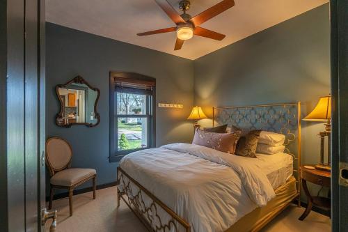 a bedroom with a bed and a ceiling fan at The Maple House Fully Fenced-in Yard! in Saugatuck