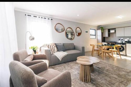 a living room with a couch and a table at Mortimer in Germiston