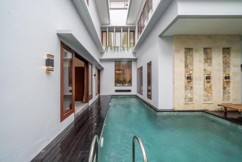 an indoor pool in a house with a large room at Modern 5BR Luxury Villa with Pool & Rooftop - 100m from Sanur Beach in Sanur