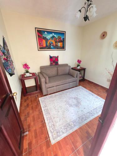 a living room with a couch and a rug at Casa Nazareno in Antigua Guatemala