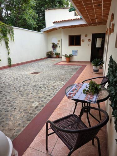 a patio with two chairs and a table on a patio at Casa Nazareno in Antigua Guatemala
