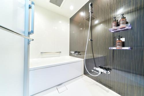a bathroom with a shower and a sink at Rakuten STAY Kokura Station in Kitakyushu
