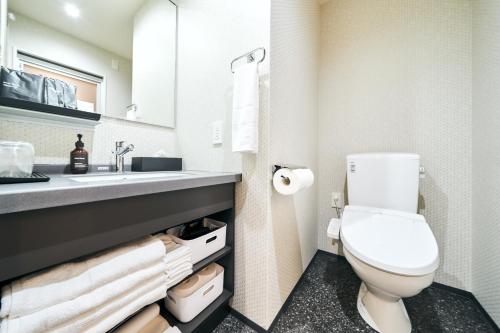 a bathroom with a toilet and a sink at Rakuten STAY Kokura Station in Kitakyushu