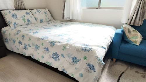 a bedroom with a bed and a blue chair at First sight hut house in Tokyo