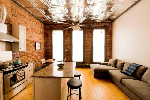 a living room with a couch and a table at Sunny Downtown Condo Above The Coffee Shop in Salida