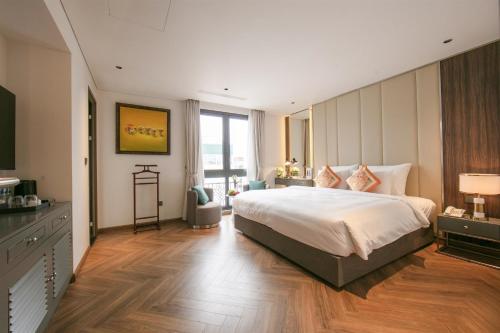 a bedroom with a large bed and a large window at Léman Old Quarter in Hanoi