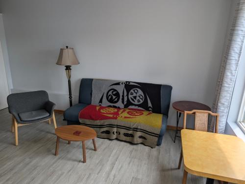 a living room with a couch and a chair at Gordie's Inn & Suites in Alert Bay