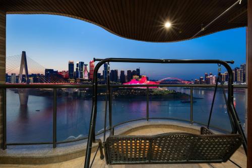 a hot tub with a view of the city at Baihong Riverview Apartment-Hongya Cave in Chongqing