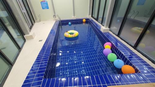 a swimming pool with balls and a toy in it at Daebudo Nurimaru Pension in Ansan