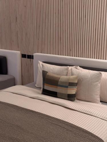 a bed with pillows on it in a room at Here Hotel 宅這兒私宅-屏市A宅 in Pingtung City
