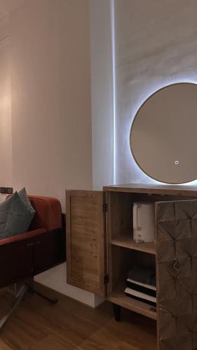 a bathroom with a large mirror and a chair at Here Hotel 宅這兒私宅-屏市A宅 in Pingtung City