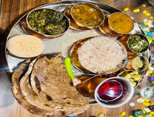 a plate of food with different types of food at Peace Forest Retreat in Gopeshwar
