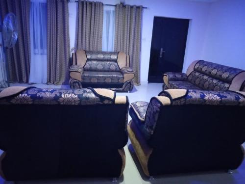 a living room with two couches and two chairs at GA guest House in Ibadan