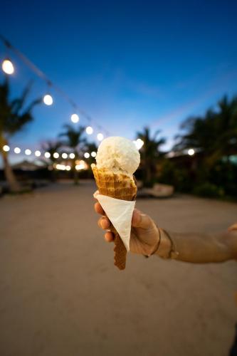 a hand holding a cone of ice cream at Wake Park Cambodia in Siem Reap