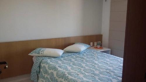 um quarto com uma cama com duas almofadas em Flat Studio Iracema apto 602 em Fortaleza