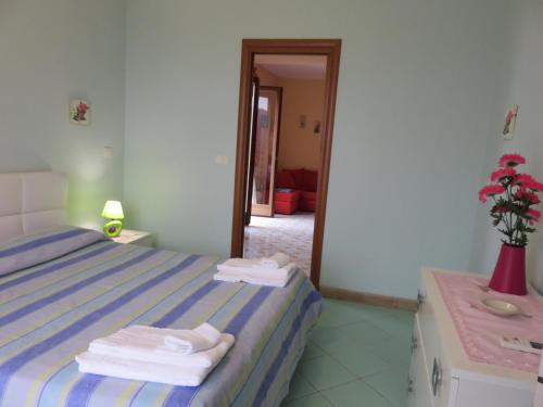 a bedroom with a bed with towels on it at Case Vacanze Residence Trinacria in Acireale