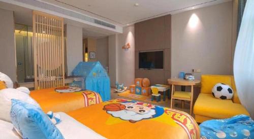 a childrens bedroom with two beds with a soccer ball on them at Quanzhou Binhai Hotel in Quanzhou