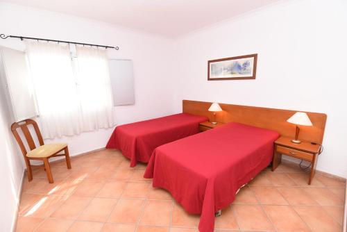 a hotel room with two beds and a window at Monte dos Avós Village - Pet Friendly in Tavira