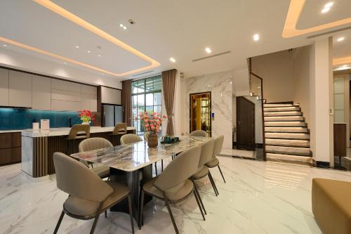 a dining room with a table and chairs at La isla Apartments & Villas - Sea View & Fireworks Phu Quoc in Phu Quoc