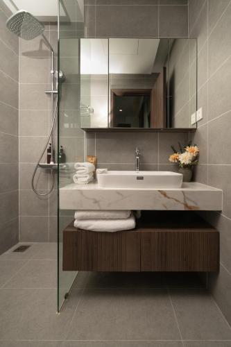 a bathroom with a sink and a shower at La isla Apartments & Villas - Sea View & Fireworks Phu Quoc in Phu Quoc