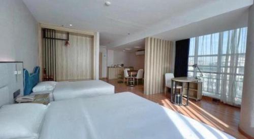 a hotel room with two beds and a large window at danfeng kelly hotel in Shenzhen
