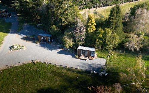 an aerial view of two small buildings in a field at Tussock Views by Tiny Away in Burkes Pass