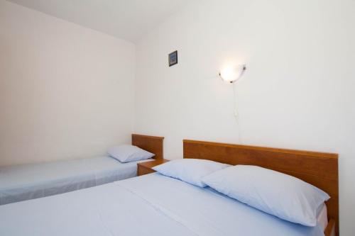 Ένα ή περισσότερα κρεβάτια σε δωμάτιο στο Apartments Bartul