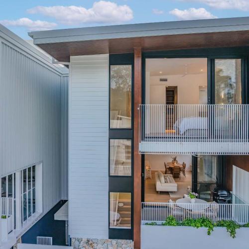 a house with a view of the living room at Urbanstayz - Lakehouse No 2- Lakefront Luxury Escape Villa - Pet Friendly in Cabarita Beach
