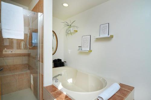 a white bathroom with a sink and a shower at Casa Salida! 1 Mile From Dwntwn, Private Hot Tub in Salida