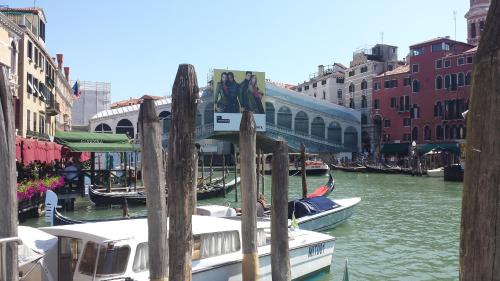 a group of boats are docked in a canal at Palazzo del Sale, Rialto in Venice