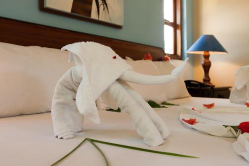 a towel elephant on a bed in a hotel room at Le Relax Self Catering Apartment in La Digue