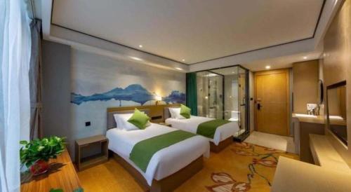 Ένα ή περισσότερα κρεβάτια σε δωμάτιο στο Shell Hotel Anhui Huaibei Railway Station Huiyuan Road