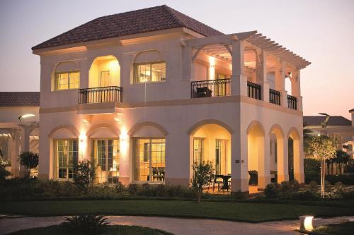 a large white house with a lot of windows at Move On Beach Resort Al Khobar in Half Moon Bay