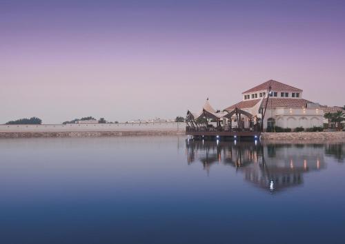 a building sitting on top of a large body of water at Move On Beach Resort Al Khobar in Half Moon Bay