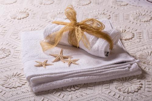 a towel with bows on it sitting on a bed at Villa Galanthus in Lístaros