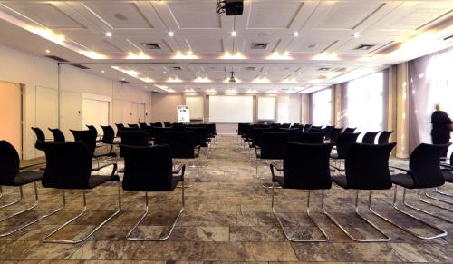 a conference room with chairs and a person standing in the background at Mercure Montpellier Centre Antigone in Montpellier
