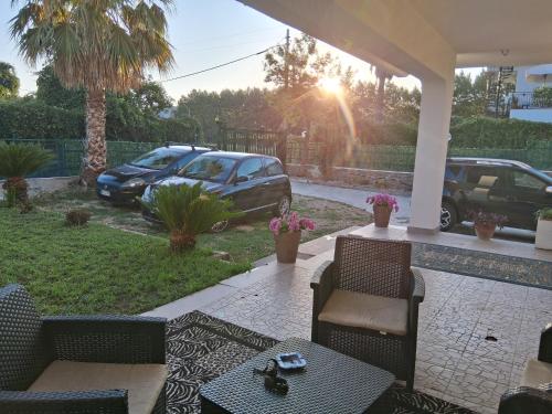 a patio with chairs and a table in a yard at Prestige Affittacamere Paestum in Stazione di Paestum