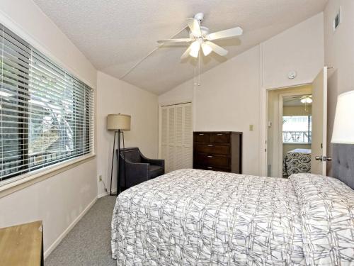 a bedroom with a bed and a ceiling fan at Lakefront Bungalow With Community Poolhot Tub #1 in Lakeway