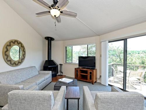 a living room with a couch and a fireplace at Treehouse Bungalow - Community Poolhot Tub #13 in Lakeway