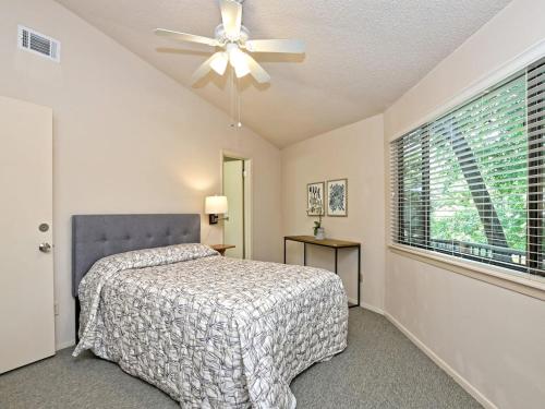 a bedroom with a bed and a ceiling fan at Lakefront Bungalow With Community Poolhot Tub #9 in Lakeway