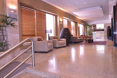 a lobby with couches and chairs in a building at Hotel Continental Luanda in Luanda