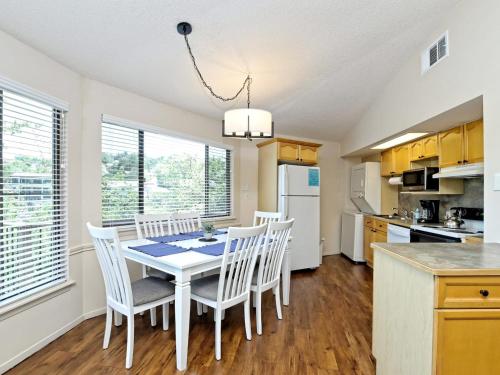 a kitchen and dining room with a table and chairs at Treehouse Bungalow - Community Poolhot Tub #17 in Lakeway