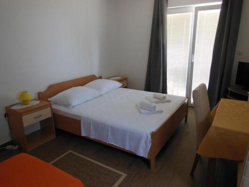 Postel nebo postele na pokoji v ubytování Apartments Maslina