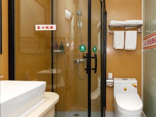 a bathroom with a shower and a toilet and a sink at Shell Hotel Shnaghai Beiqiao Metro Station in Shanghai