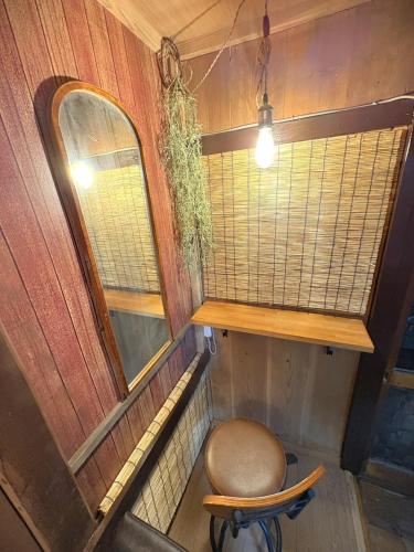an empty room with a chair and a window at Nikko-Imaichi "The LINKs" Dormitory House in Nikko